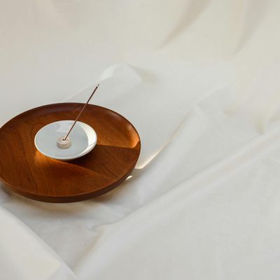 Burning incense sticks on a small stone plate