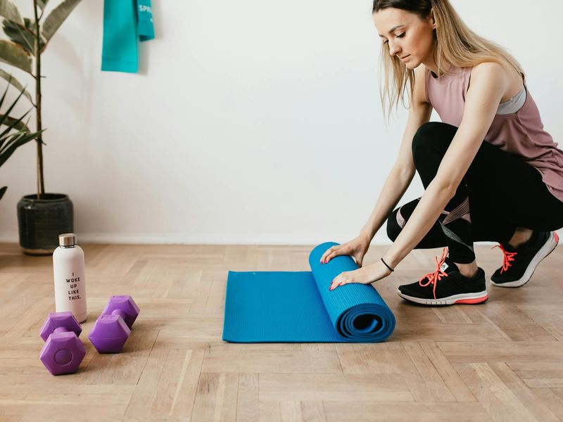 Detailed view of yoga equipment and a mat on wooden floor